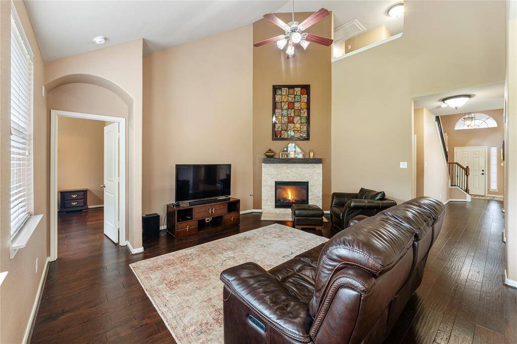 High ceilings and the corner fireplace add character to the family room