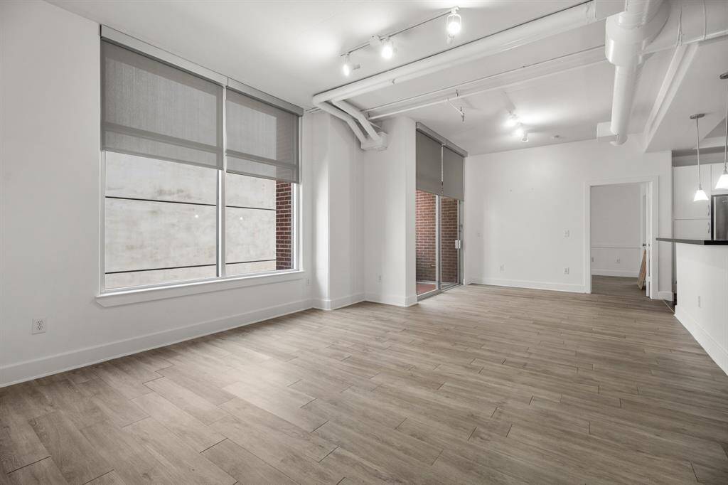 High ceilings and wall of windows allow for a light and bright living and dining area.