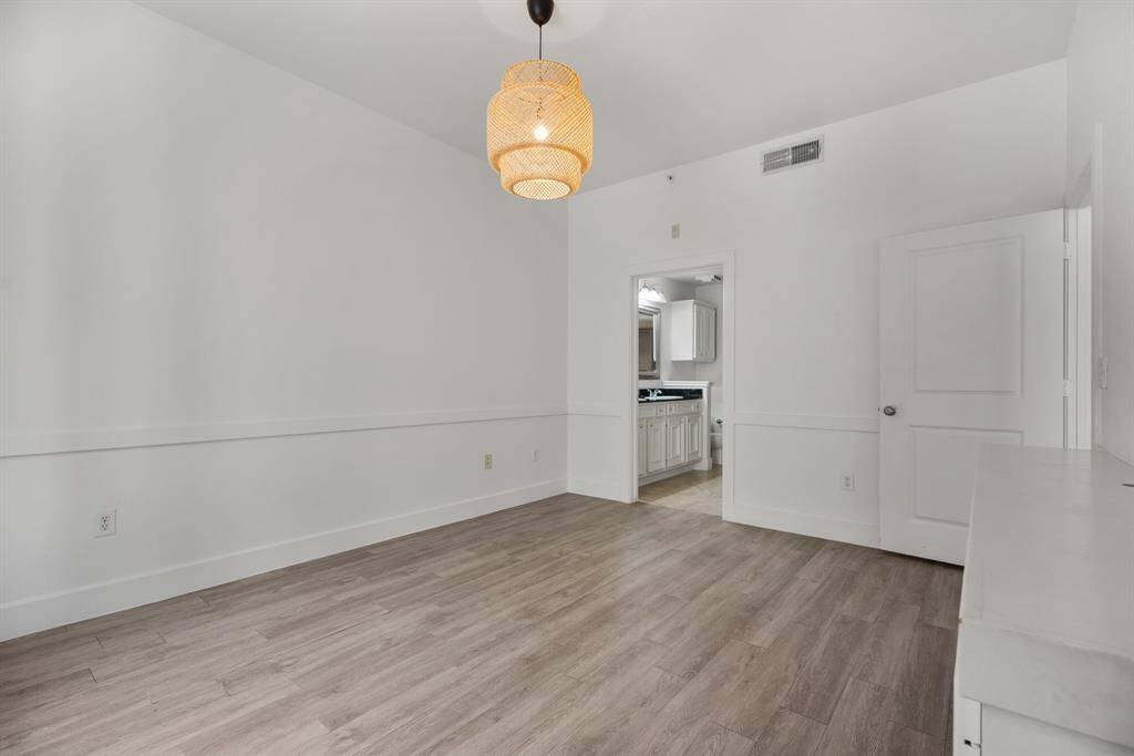 Primary bedroom with laminate flooring