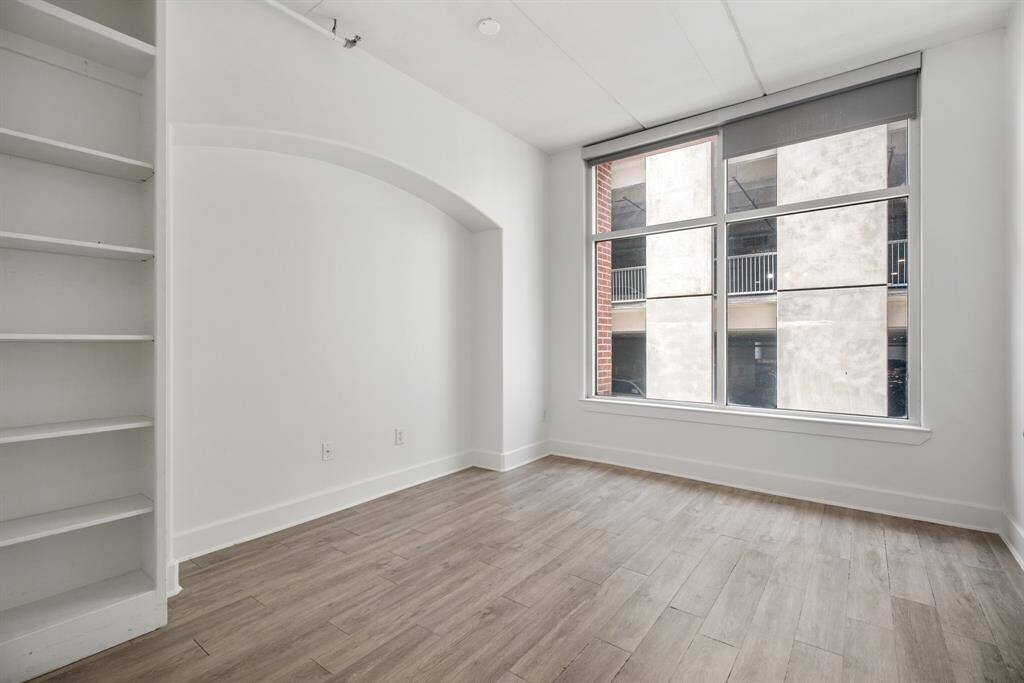 2nd of 3 bedrooms will make a great home office with large window and builtin bookcase.