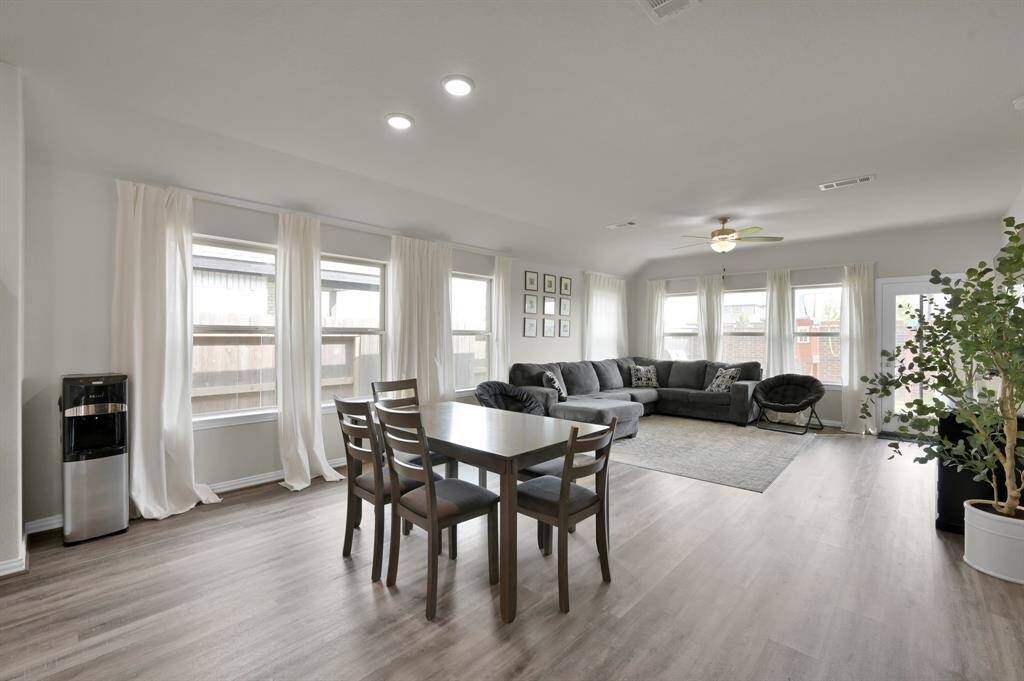 Dining area with large windows overlooking the backyard, perfect for bright, cheerful meals.