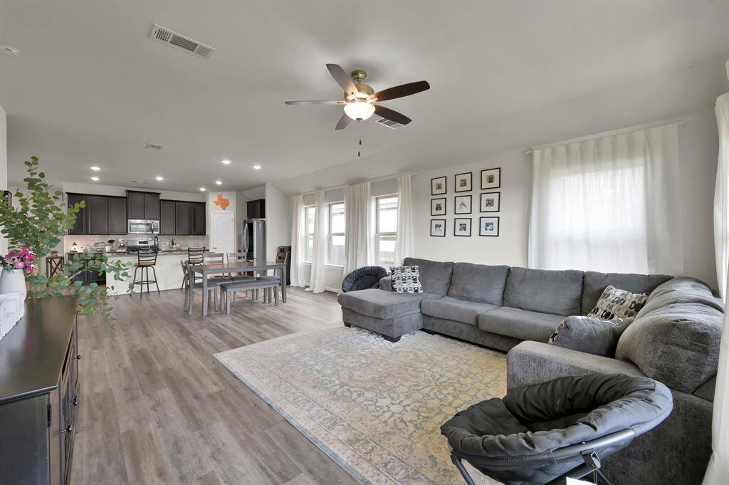 Cozy and comfortable living room with ceiling fan.