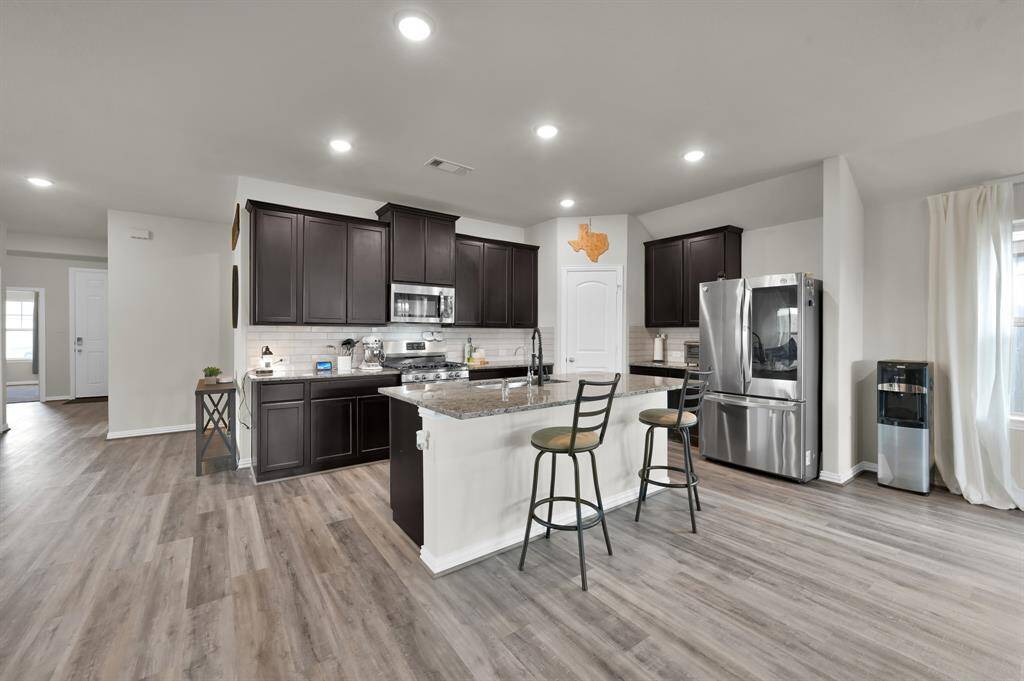 Spacious and open-concept kitchen and dining area, perfect for family meals and entertaining guests.