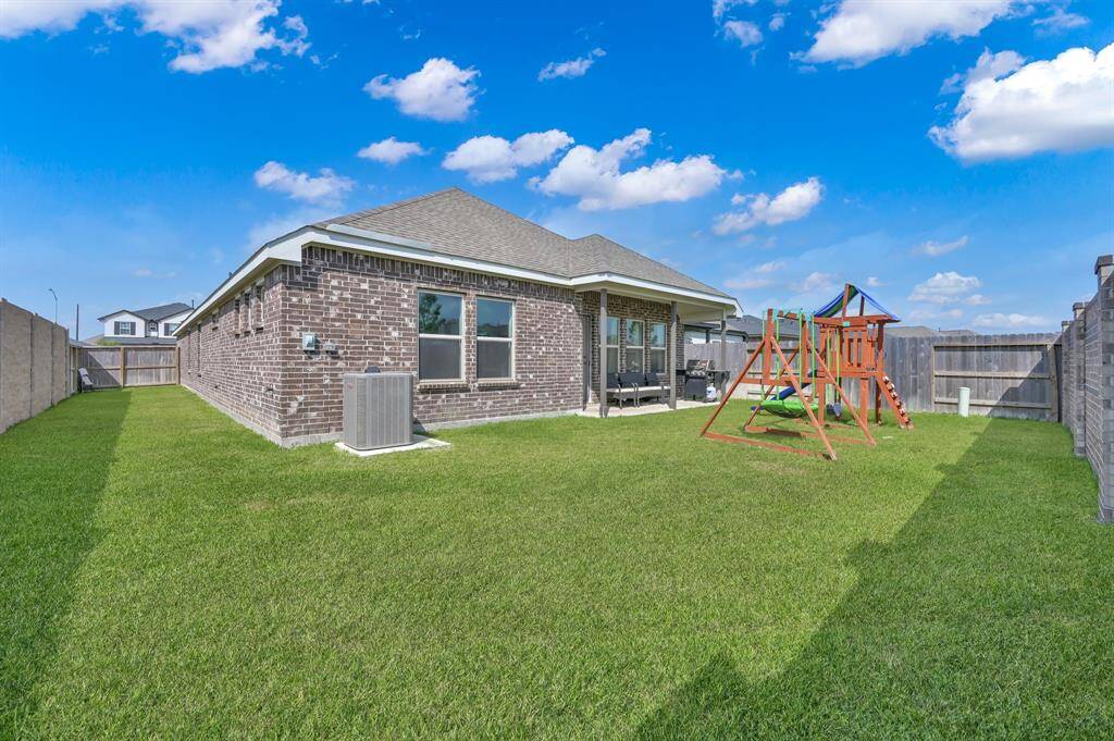 Backyard view with ample green space for play or gardening.