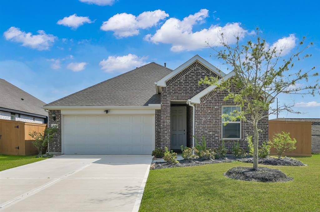 Another angle of the home showcasing the well-maintained lawn and upgraded sprinkler system.