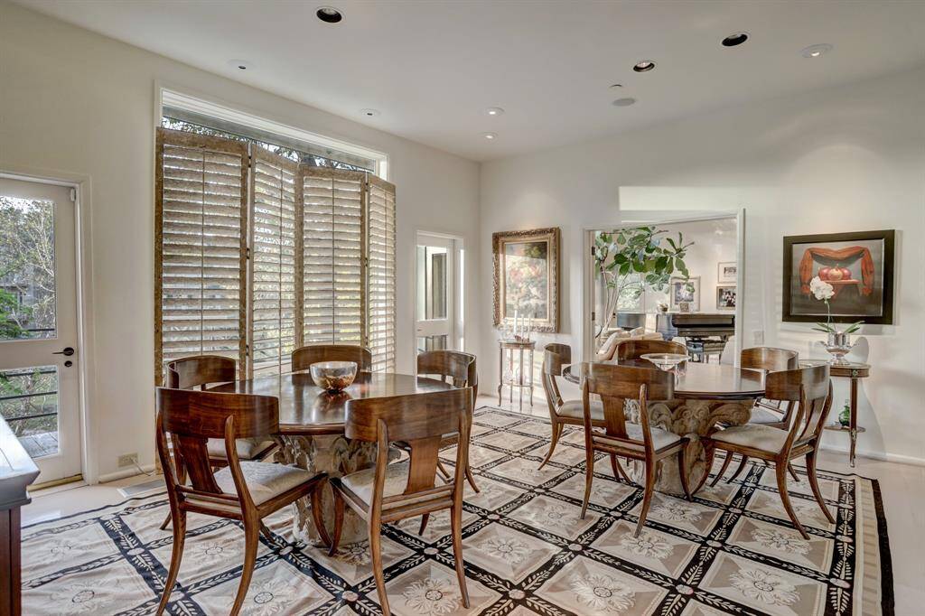 The dining room showcases French doors provide seamless access to outdoor entertaining spaces, making it an ideal setting for dinner parties and gatherings.