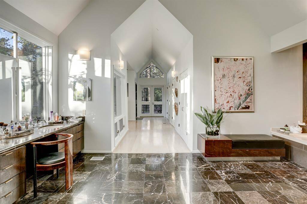 Experience a sanctuary of elegance and tranquility in this primary bathroom!