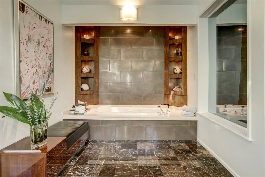 The primary bathroom exudes serenity with this large jetted-tub.