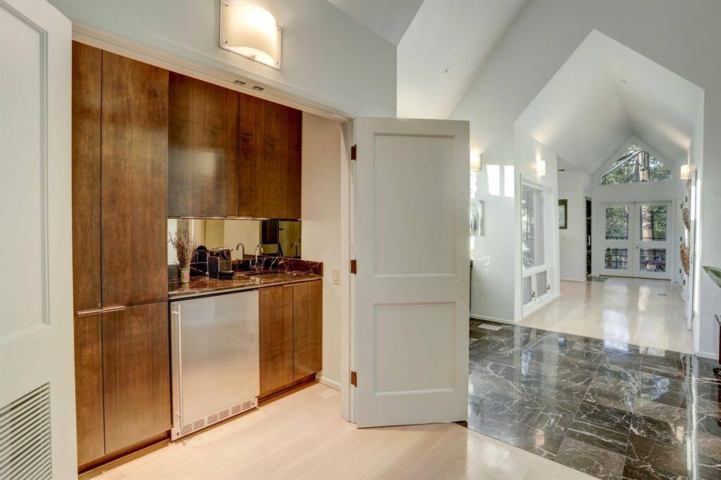 Nestled within an alcove, this luxurious wet bar and coffee bar area inside the primary bathroom is a testament to thoughtful design.