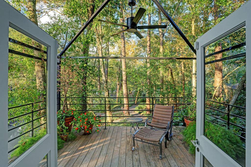 This deck located off of the Primary suite surrounded by lush trees and grenery.