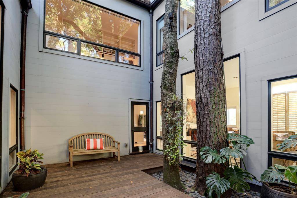 This open-air atrium harmonizes with the lush, landscaped grounds.