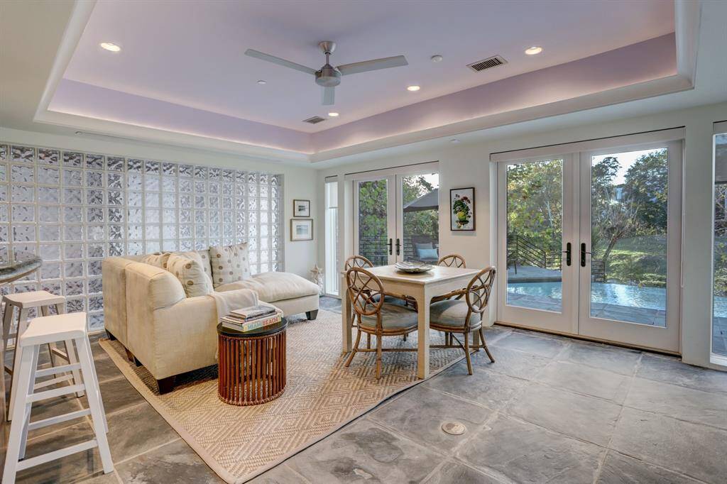 The lower-level game room with access through a set of French doors to the backyard patio.