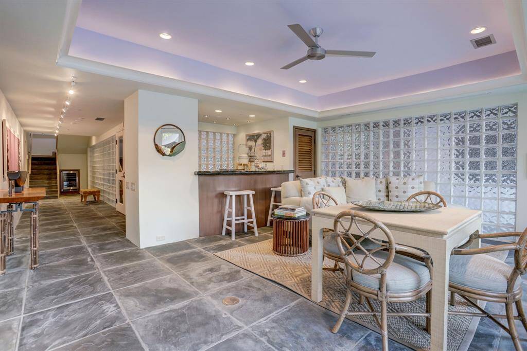 The game room is a versatile and inviting space, featuring an adjacent wet bar for convenient refreshments.
