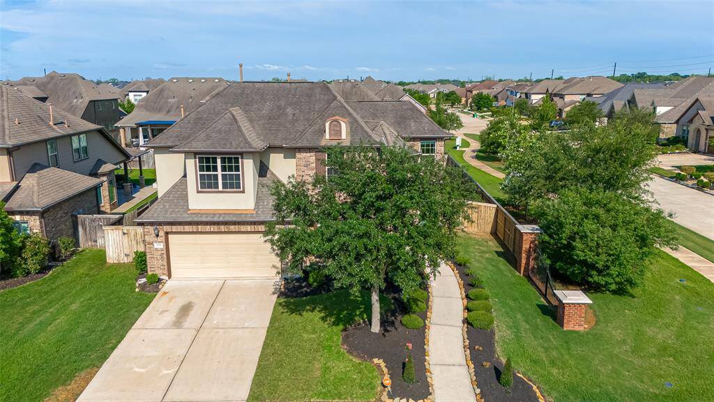 The house is in a suburban neighborhood with similar style homes and features a fenced backyard.