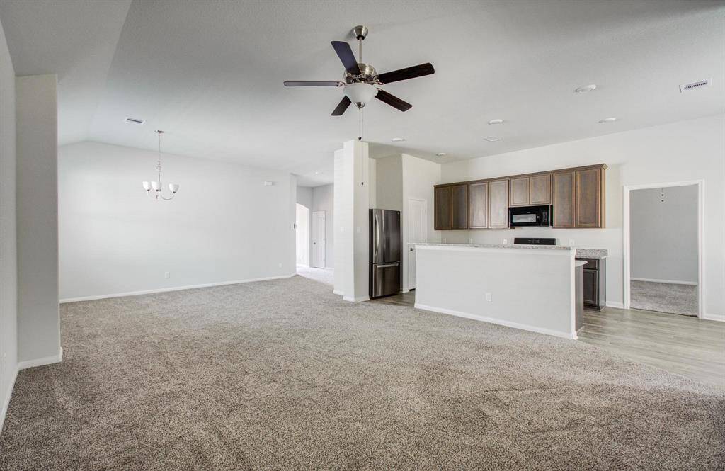Kitchen looks into living area