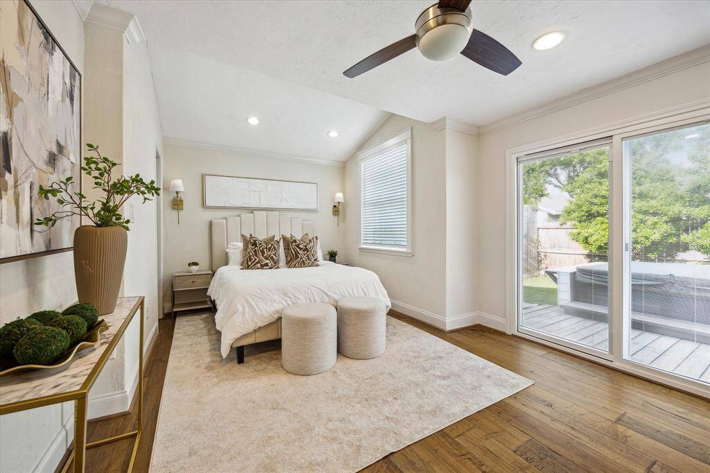 The spacious primary suite is a true retreat, featuring vaulted ceilings, recessed lighting, and direct access to the backyard spa through sliding glass doors—blending comfort with a touch of luxury.