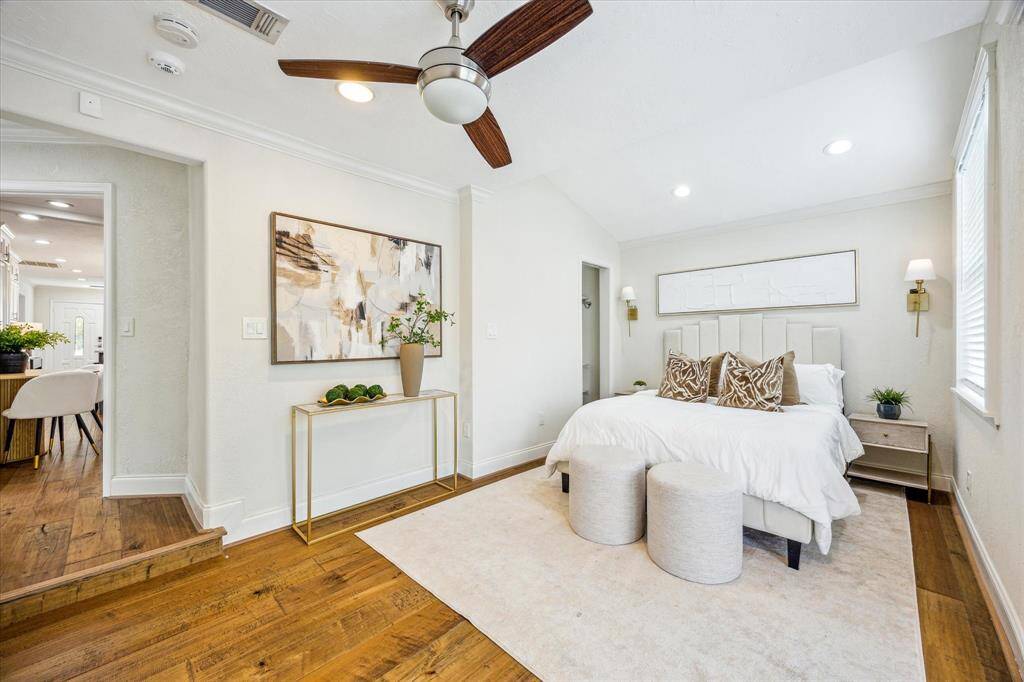 Thoughtfully designed for relaxation, the primary bedroom offers warm hardwood floors, modern lighting, and an ensuite bath, all just steps from the main living spaces for easy convenience.