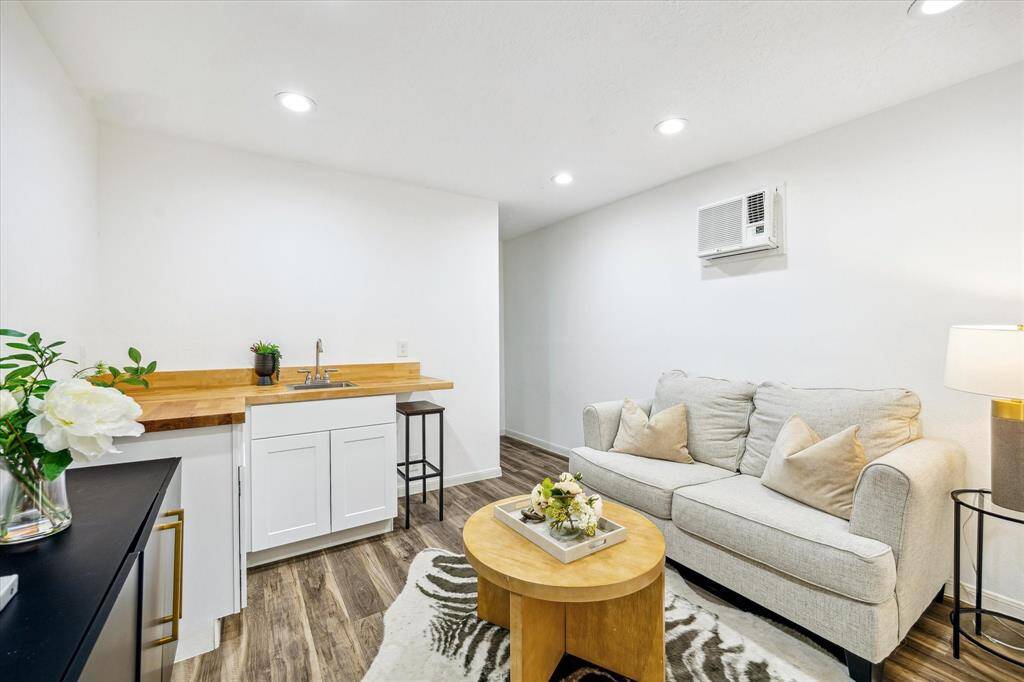 A versatile bonus space with endless potential—this converted garage features an open space, butcher block counter with sink, and private entry. Ideal as a guest suite, home office, or creative studio.