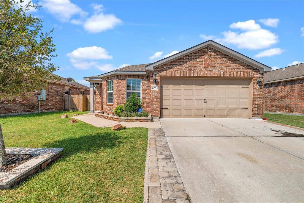 Inviting front elevation featuring a blend of brick and clean lines for a timeless look.