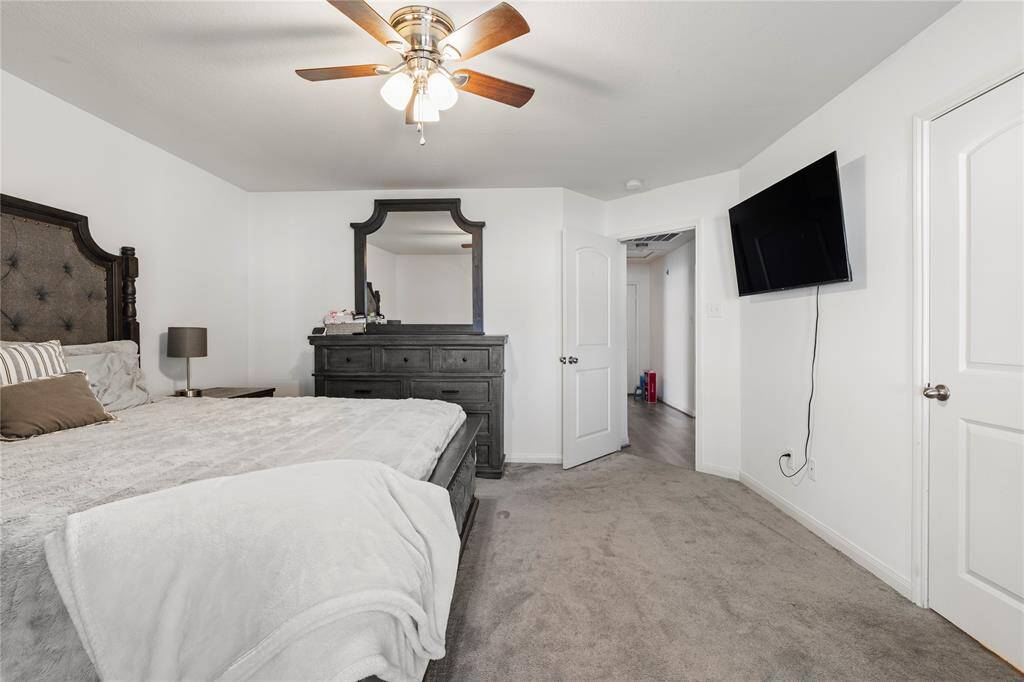 Peaceful primary bedroom designed for rest and relaxation.