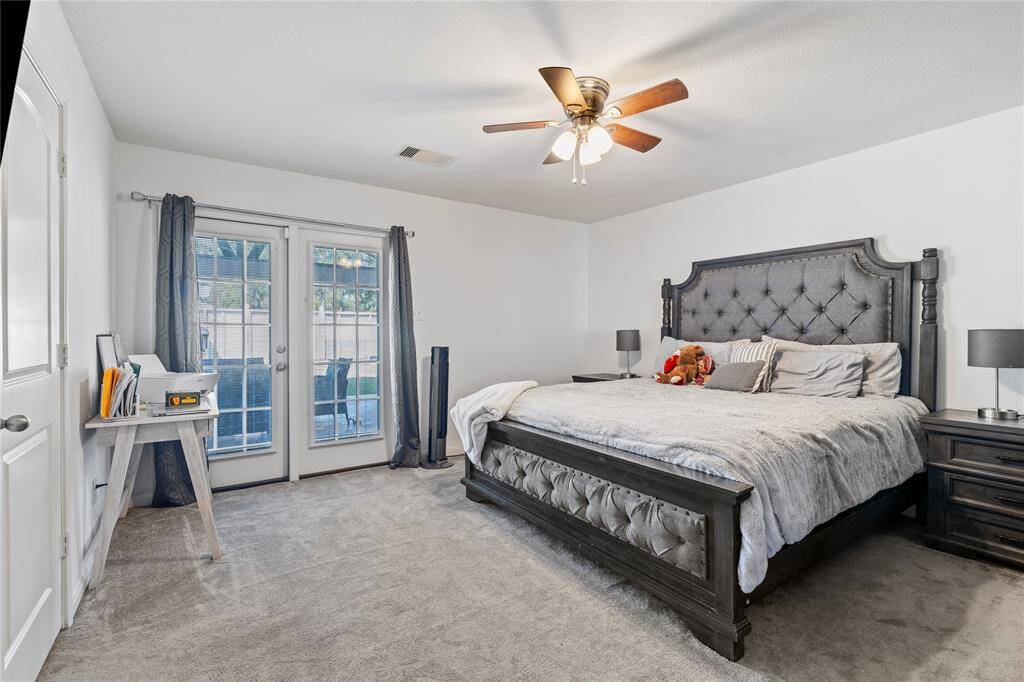 Relax in the spacious primary suite with plush carpet and tranquil views of the backyard.