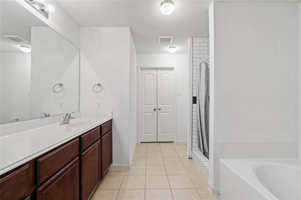 Primary bathroom with ample space to unwind.