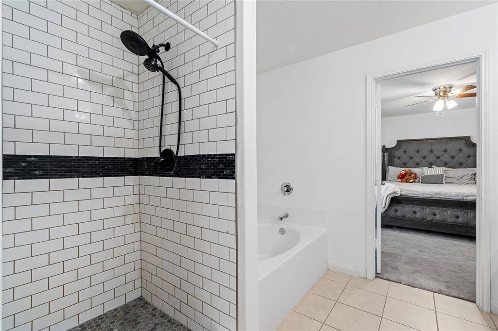 Primary bathroom with a large soaking tub and walk-in shower.
