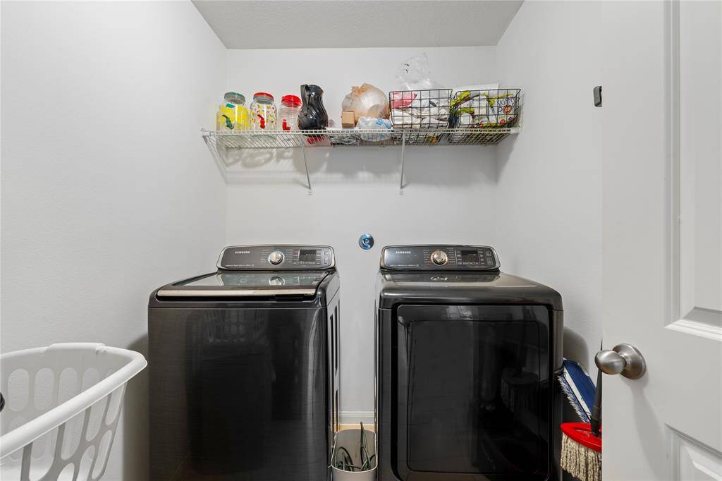 Dedicated laundry room with hookups for a washer and dryer, featuring extra storage options.