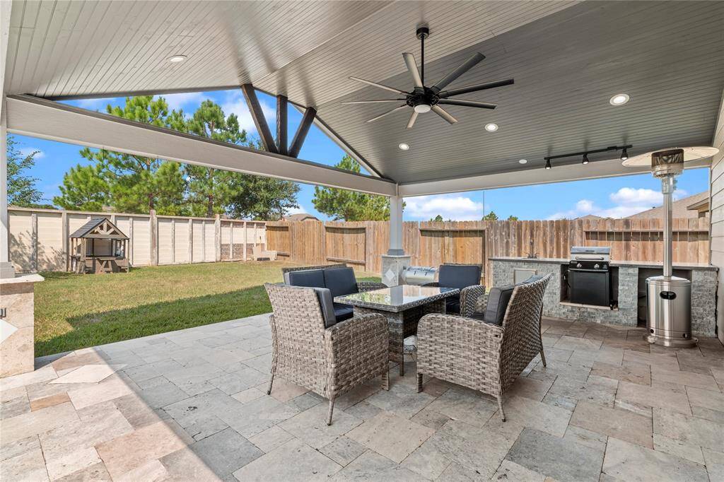Fully equipped outdoor kitchen, ready for grilling and entertaining under the covered patio.