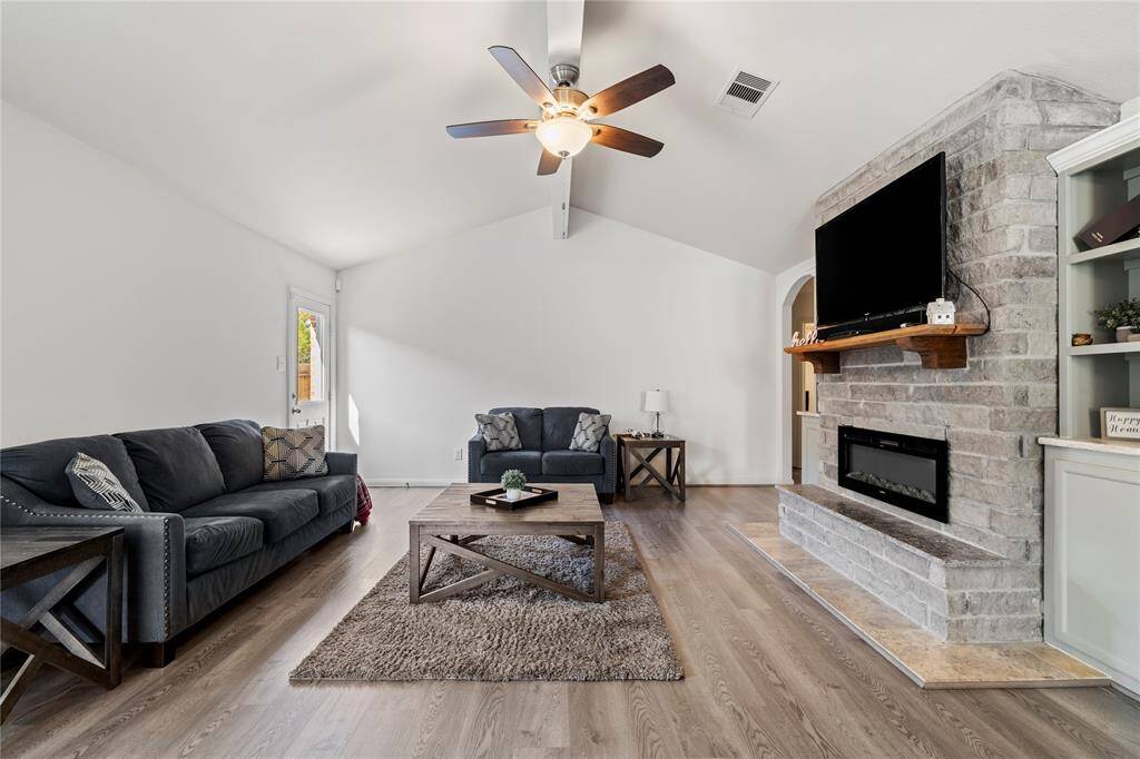 Spacious living room with high ceilings and a cozy ambiance, perfect for entertaining.