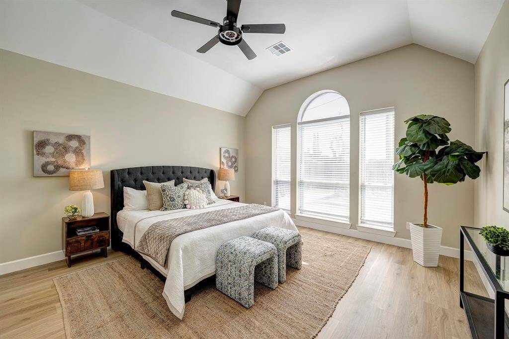 The primary bedroom has vaulted ceilings and a large window with views to the pool!
