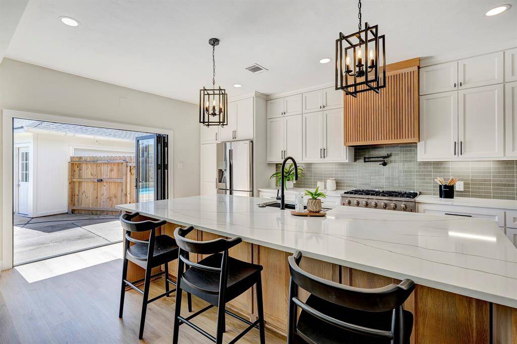 The kitchen has a huge collapsing glass door that opens seamlessly to the pool, creating the perfect backdrop for indoor-outdoor living. It's a standout feature that truly elevates the lifestyle this home offers—and one you're sure to love.