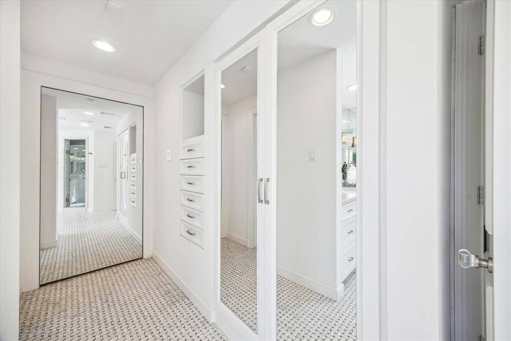 Behind the mirrored wall is one of the three spacious walk-in closets.