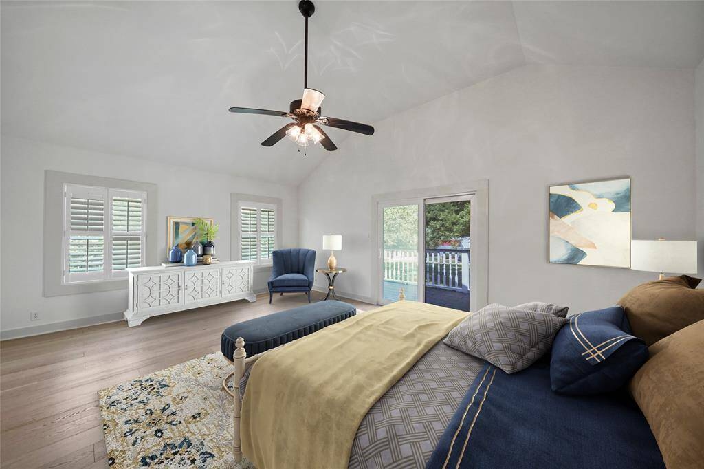 Peaceful primary bedroom with high ceilings and direct access to balcony.