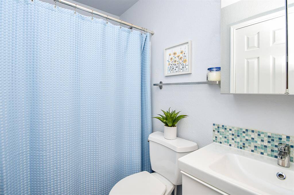 Combined shower/bathtub appeals to personal options in this secondary bathroom.