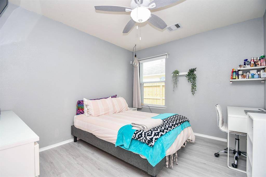 A roomy secondary bedroom hosts good-sized pieces. A corner window gives you more wall/floor space for favorite accents.