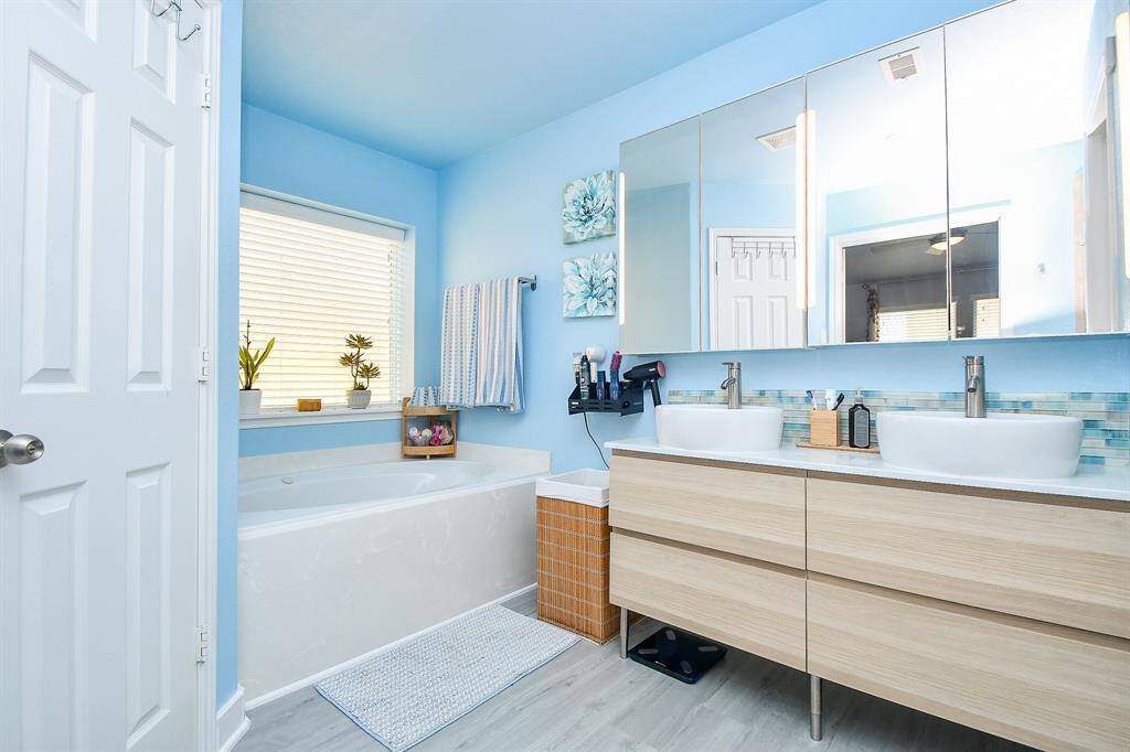 Amazing counter space is yours to fill, while a soak in the tub (left) will relax and refresh, anytime of day or night.