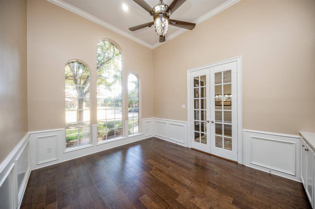A gorgeous high ceiling embraces triple arched windows, wood floors and tremendous space in this lovely front room, with pure natural light, and private french doors.