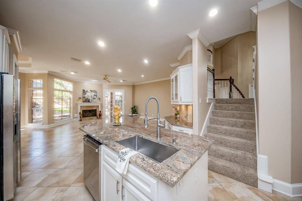 This marvelous kitchen area is bound to become 'family central', open to common living spaces, with a slip of carpeted stairs descending directly into this wide open area.