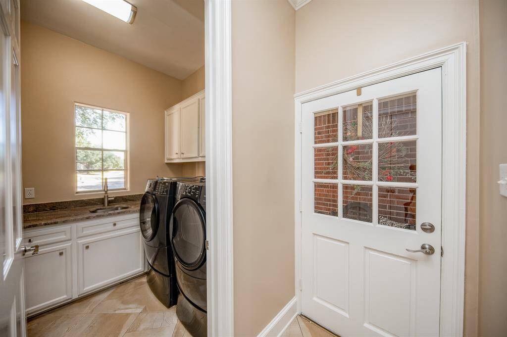 A spacious utility room sits just off the handy patio door.
