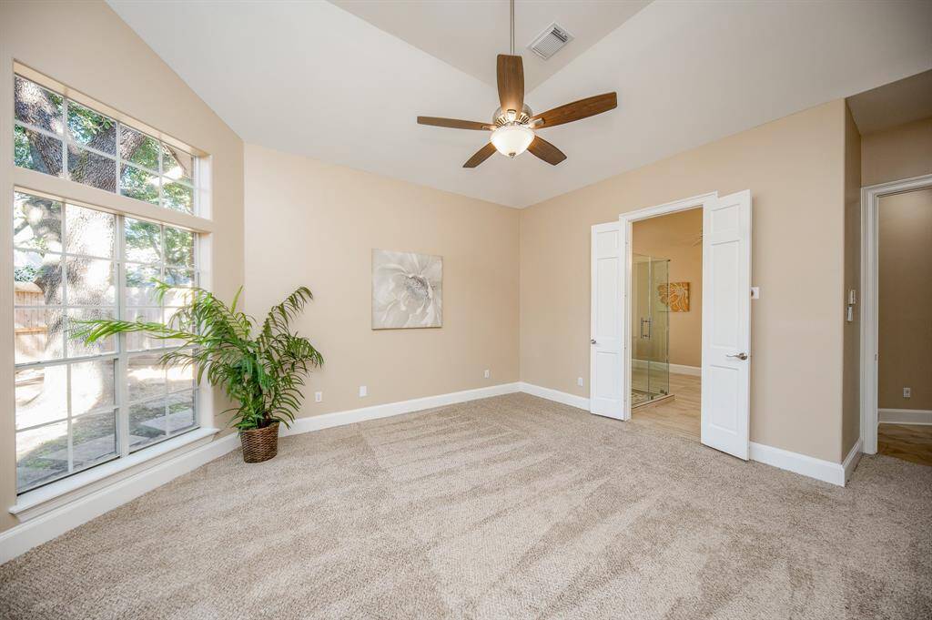The ensuite bath, behind double doors,  right, is just footsteps from your luxurious primary suite.