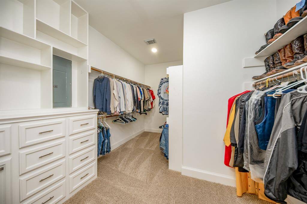 Carry your phone with you when you enter this unbelievable primary walk-in closet! You don't want to get lost!