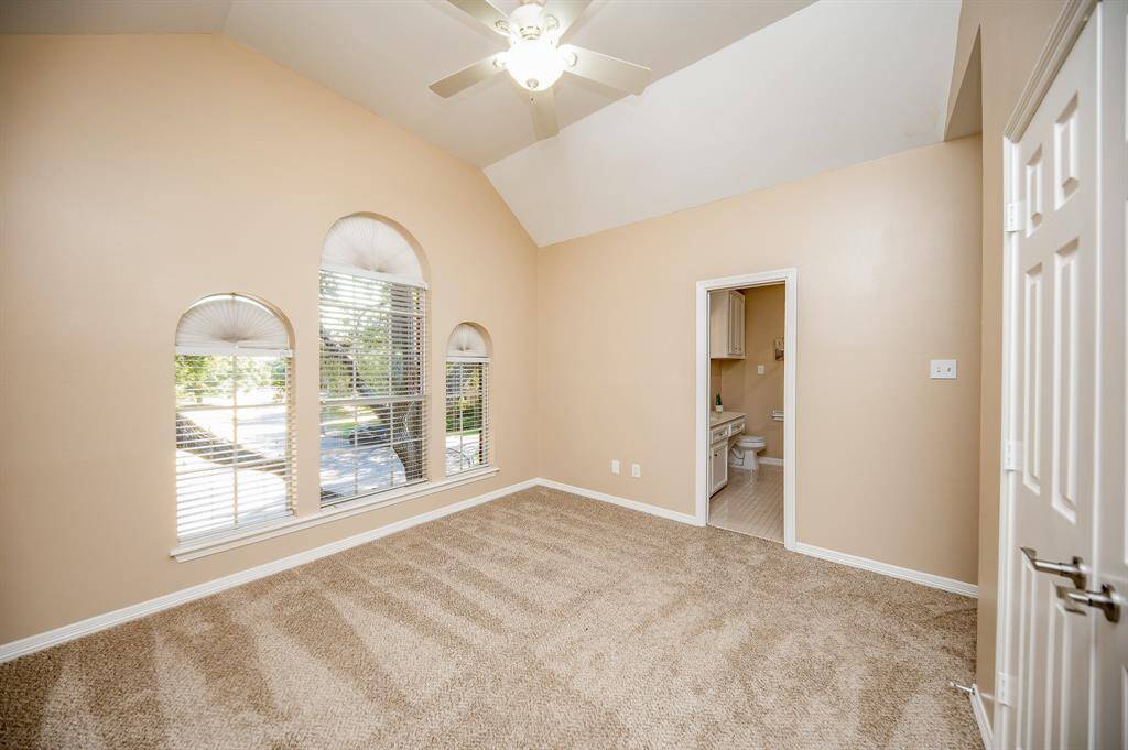 A secondary bedroom with new carpeting offers its own lush ensuite bath.