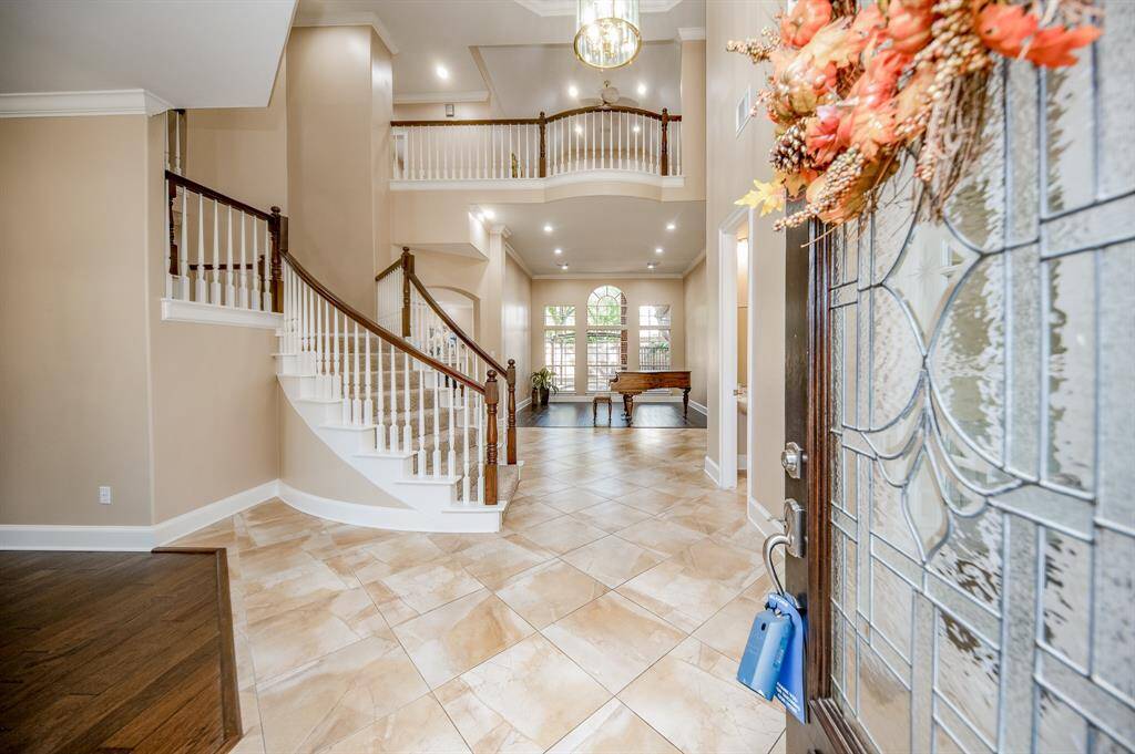 The stunning etched glass front door opens onto your first amazing view of the 1st floor entry/main hallway and foyer, featuring its striking carpeted spiral staircase, up to the grand 2nd level balconies overlooking the elegant 1st level entry. Bright, light and amazing!