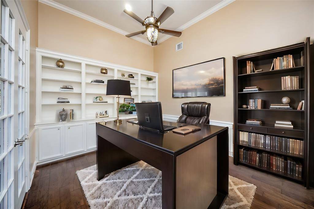 Here's another striking view of the 1st floor 'home office' beyond french doors, with a wall of built-in shelving/cabinetry to host an array of books and/or favorite trophies, awards, and family treasures.