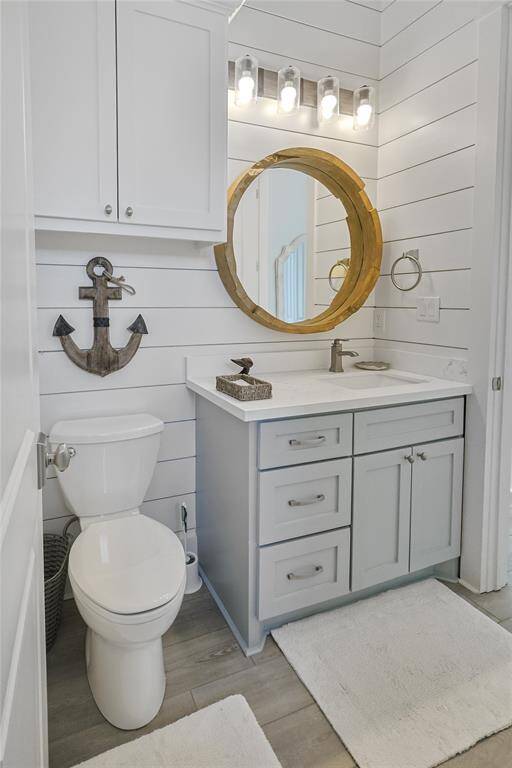 Gorgeous shiplap added to this bathroom that is accessible from the front of the home and the first floor primary.