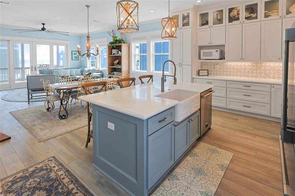 Experience the perfect blend of space and style in this open-concept kitchen, dining, and living area. Flooded with natural light, this inviting space offers seamless flow for entertaining and everyday living, all while showcasing stunning Gulf views.