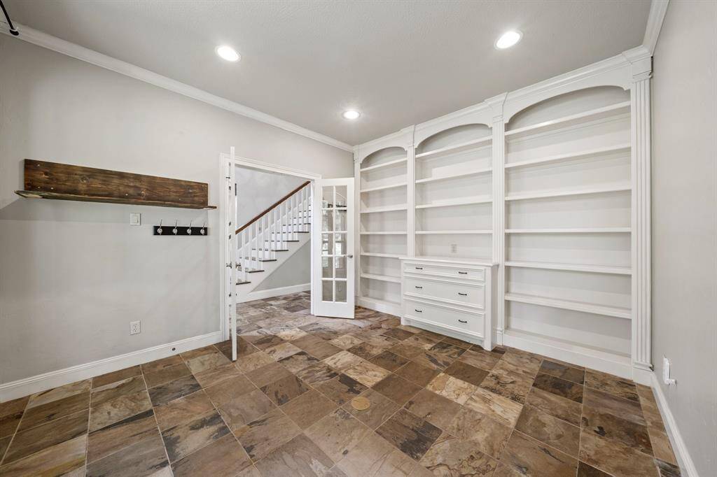 Slate mosaic brown tiles enhance the home's classic style, while light grey walls and white baseboards add to the sense of spaciousness.