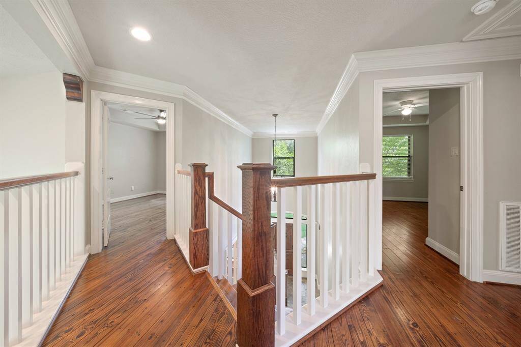 Upstairs, the slate flooring gives way to rich dark hardwood that graces the spacious bedrooms, adding a charming vintage touch to an already impeccable home.