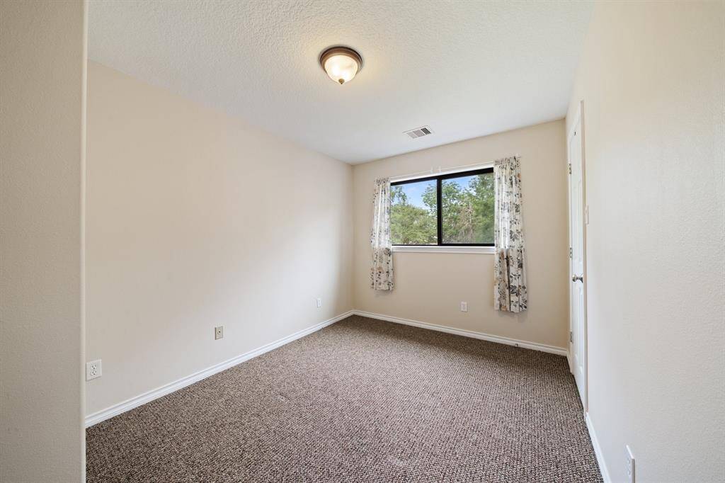 This small cozy room, featuring a sleek window and carpeted floor, is sure to be a comfortable retreat.